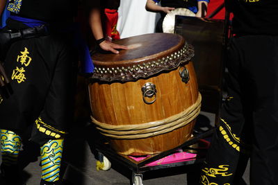 Midsection of man wearing costume while standing by drum during event