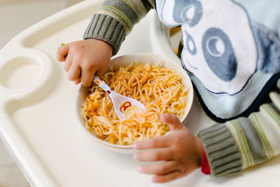 Close-up of hands holding food on table