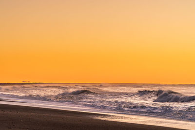 Scenic view of sea against clear sky during sunset