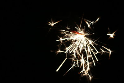 Low angle view of firework display at night