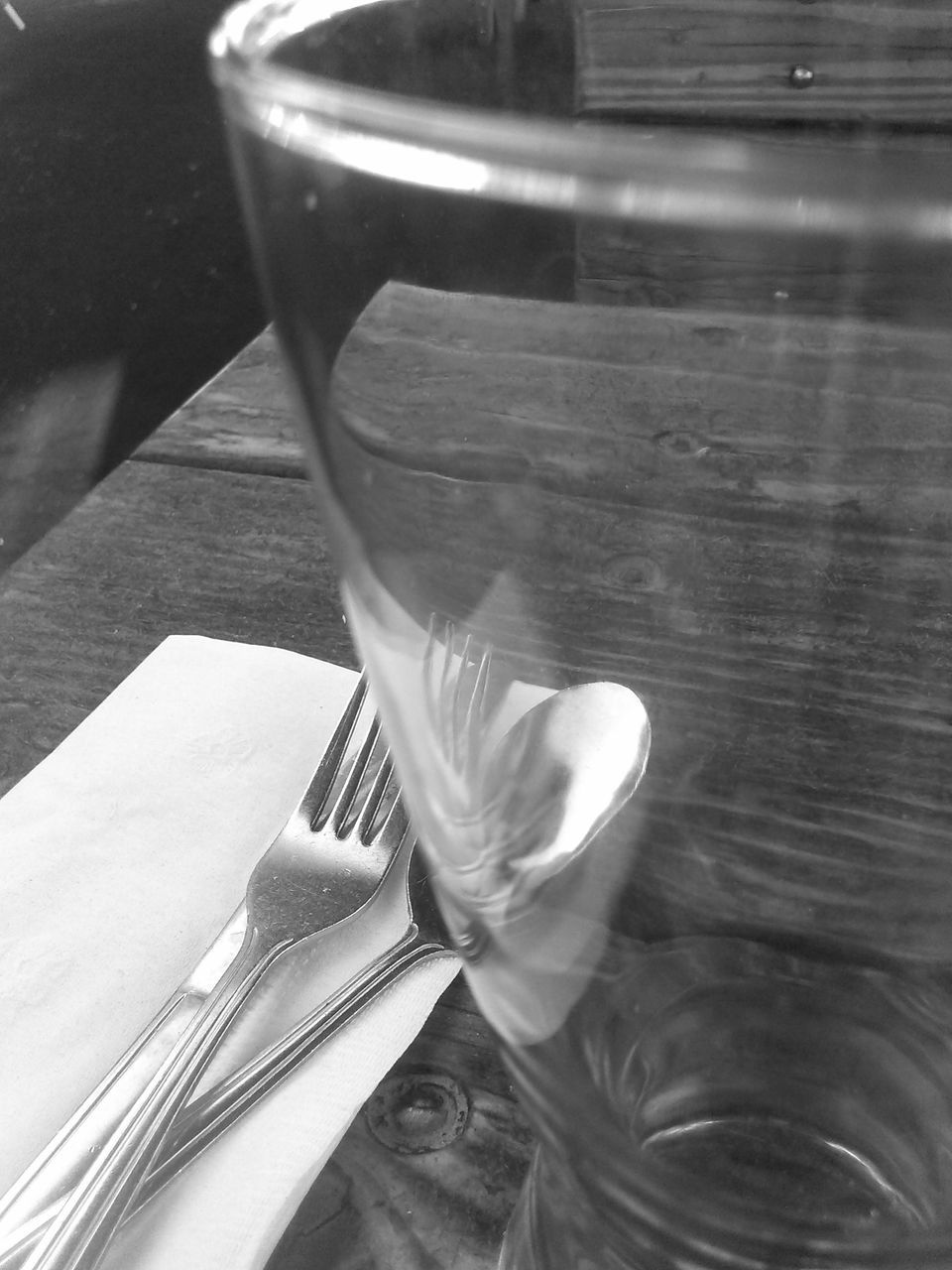 indoors, table, still life, high angle view, close-up, drink, drinking glass, food and drink, refreshment, wood - material, two objects, empty, no people, book, reflection, shoe, single object, glass - material, fork, absence