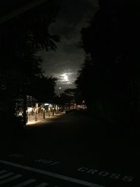 View of illuminated street lights at night