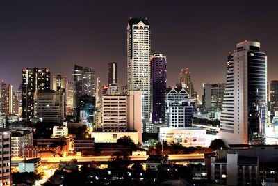 View of skyscrapers lit up at night