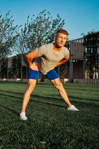 Full length of man exercising on field