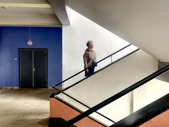 Man standing on staircase of building