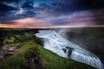 Scenic view of gullfoss falls against cloudy sky
