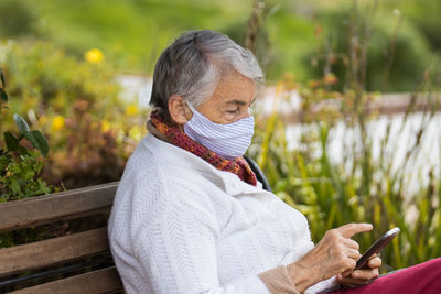 Midsection of man using mobile phone outdoors