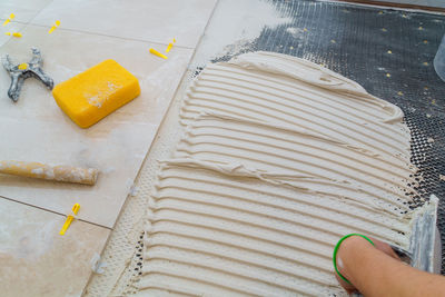 High angle view of person preparing food on floor