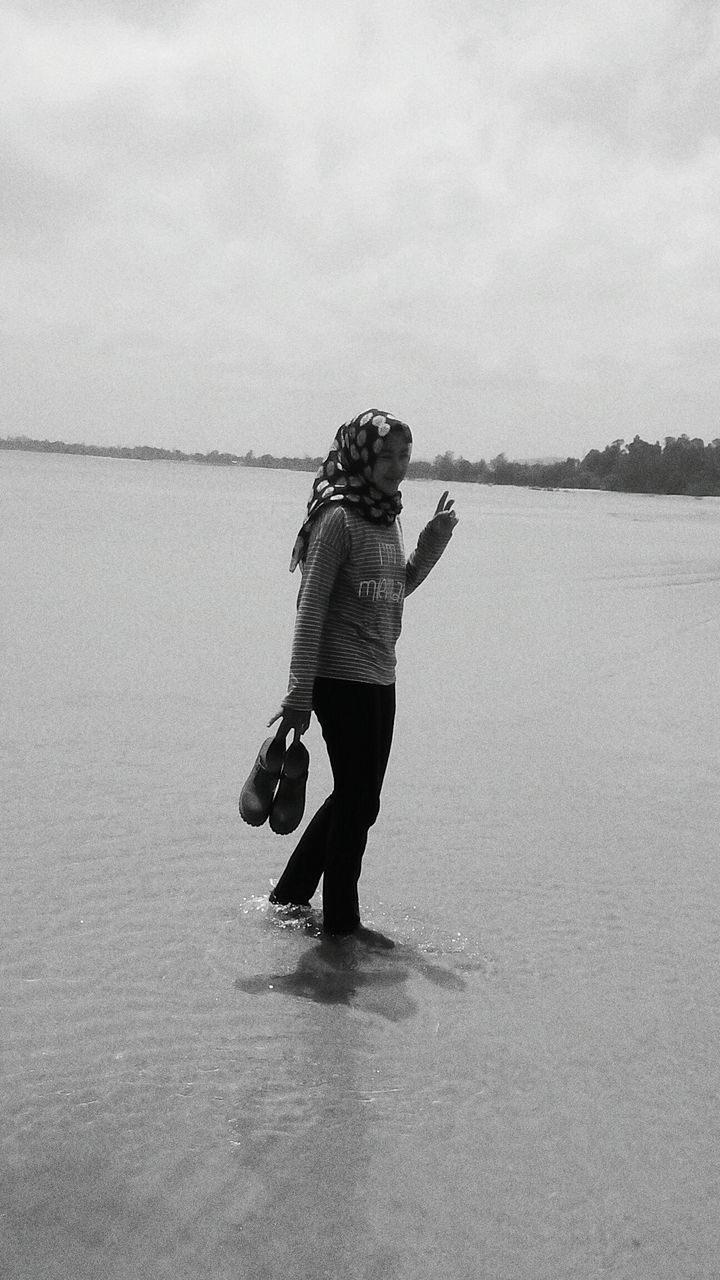 WOMAN STANDING IN WATER