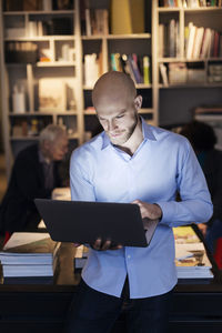 Young businessman using laptop in office