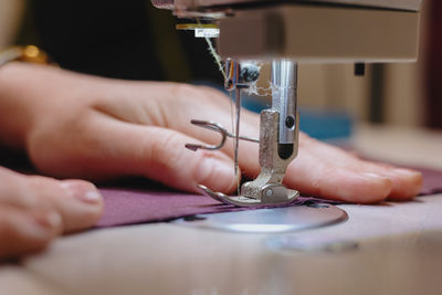 Cropped hands sewing machine