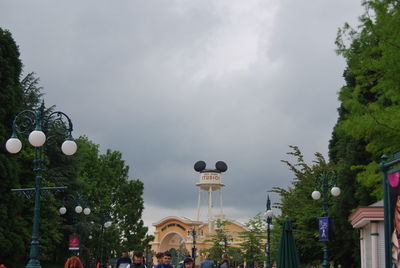 Low angle view of trees and buildings against sky