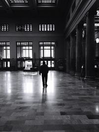 Rear view of man standing at subway station