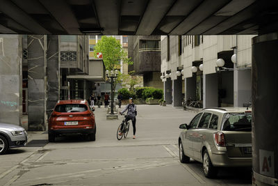 Cars parked on street by buildings in city