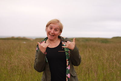 Portrait of a smiling young woman on field