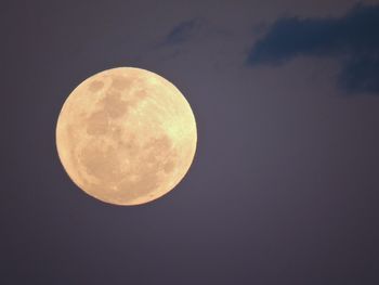 Low angle view of moon against clear sky at night