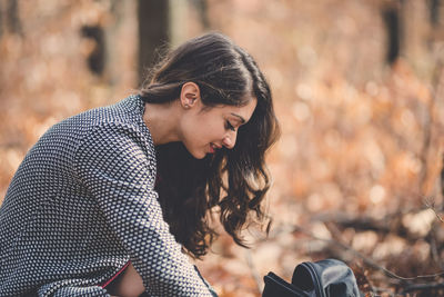 Side view of young woman looking away outdoors