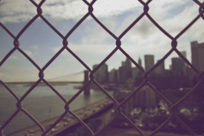 Close-up of chainlink fence against sky