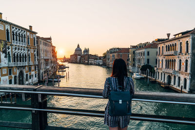 Rear view of woman standing on a bridge