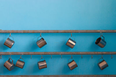 Close-up of clothes hanging on blue wall