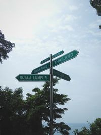 Low angle view of road sign against sky