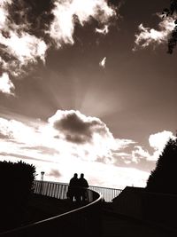 Silhouette railing against sky