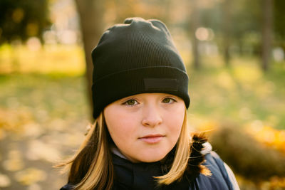 Portrait of young woman wearing hat