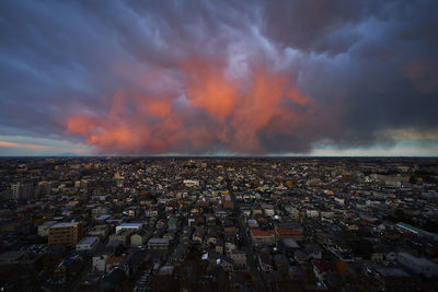 Aerial view of cityscape against sky during sunset