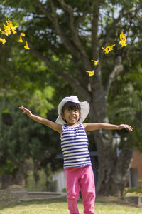 Girl looking at flowers on field