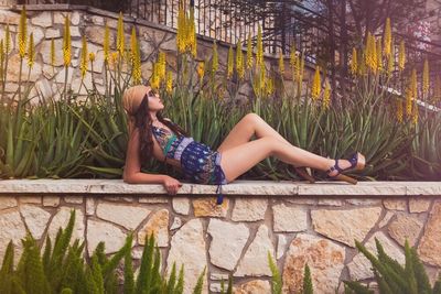 Rear view of woman sitting on bench