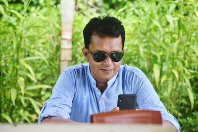Portrait of mid adult man using mobile phone
