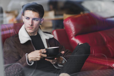 Man looking at camera while sitting on seat