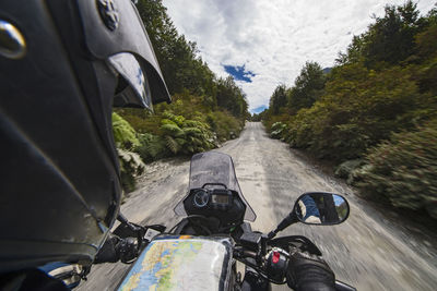 Man driving on a touring motorbike gravel road on carretera austral