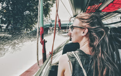 Young woman looking away in boat