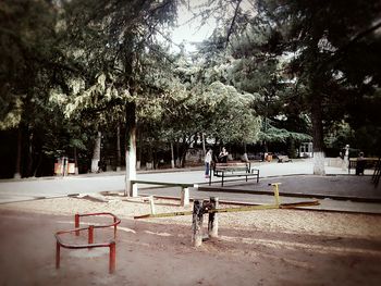 Man sitting on dog against trees