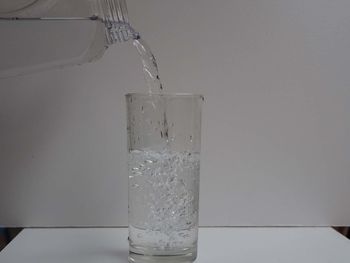 Close-up of glass pouring water