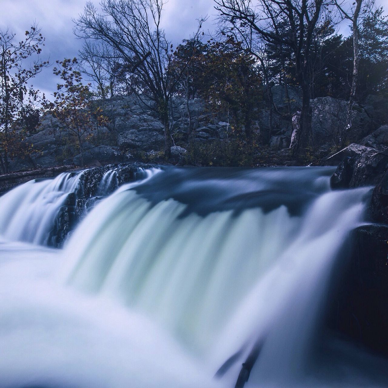 winter, cold temperature, snow, flowing water, tree, water, season, flowing, frozen, beauty in nature, waterfall, motion, nature, scenics, weather, forest, long exposure, tranquility, river, tranquil scene