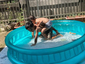 Rear view of woman in swimming pool