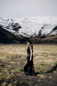 Full length side view of man standing on rock