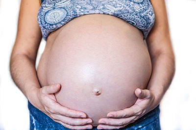 Midsection of woman touching baby