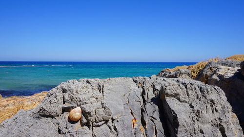 Scenic view of sea against clear blue sky