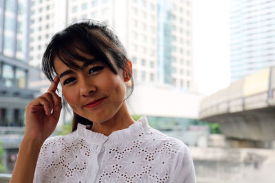 Portrait of smiling mid adult woman in city