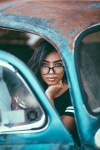 Portrait of smiling young woman in car