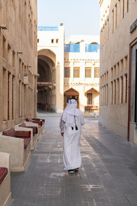 Qatari men walking in souq wakif back view no face