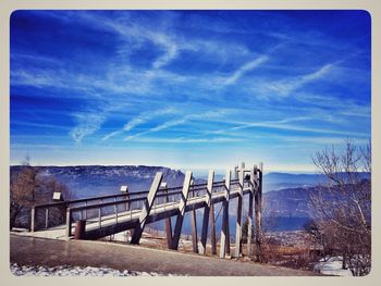 Scenic view of landscape against blue sky during winter