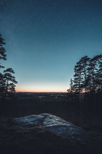 Scenic view of landscape against clear sky at night