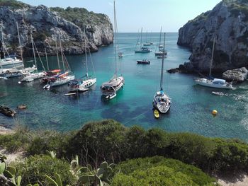 Sailboats moored in sea