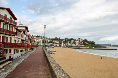 Panoramic view of beach and buildings against sky