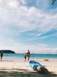 People on beach against sky