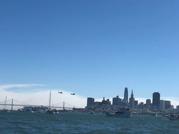 Scenic view of sea by buildings against sky